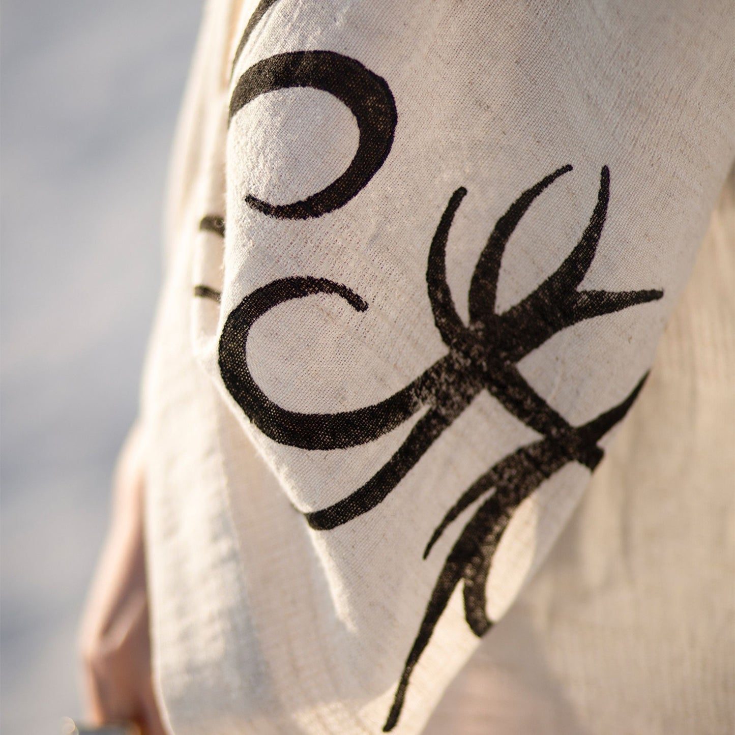 Unisex linen and hemp kimono robe with hand-block printed boho pattern, styled as beach cover-up